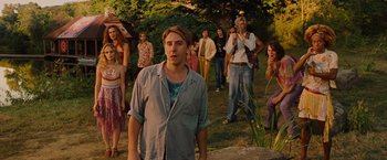 Movie still from “Across the Universe” (2007), directed by Julie Taymor – A group of people standing in the grass; Wide shot, Over the shoulder angle
