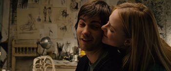 Movie still from “Across the Universe” (2007), directed by Julie Taymor – A man and a woman kissing in front of a wall; Close Up shot, Low angle