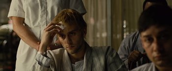 Movie still from “Across the Universe” (2007), directed by Julie Taymor – A man with a cigarette in his mouth; Close Up shot, High angle