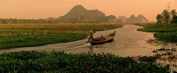 Movie still from “Act of Valor” (2012), directed by Scott Waugh – A person on a boat on a body of water; Extreme Wide shot, High angle