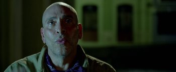 Movie still from “Act of Valor” (2012), directed by Scott Waugh – A man with a shaved head is making a funny face; Close Up shot, Low angle