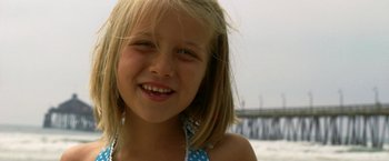 Movie still from “Act of Valor” (2012), directed by Scott Waugh – A young girl smiling for the camera; Close Up shot, High angle