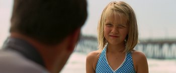 Movie still from “Act of Valor” (2012), directed by Scott Waugh – A little girl standing next to a man on the beach; Close Up shot, Over the shoulder angle