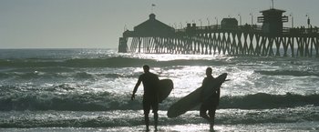Movie still from “Act of Valor” (2012), directed by Scott Waugh – Two men holding surfboards walk into the ocean; Extreme Wide shot, Low angle