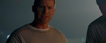 Movie still from “Act of Valor” (2012), directed by Scott Waugh – A person wearing a white t - shirt; Close Up shot, Low angle