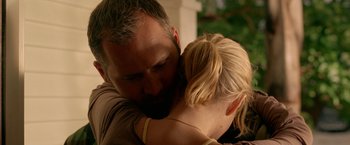 Movie still from “Act of Valor” (2012), directed by Scott Waugh – A man and a woman hugging each other; Close Up shot, Over the shoulder angle