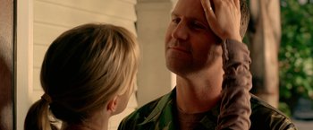 Movie still from “Act of Valor” (2012), directed by Scott Waugh – A man and a child looking in the same direction in the mirror; Close Up shot, Over the shoulder angle