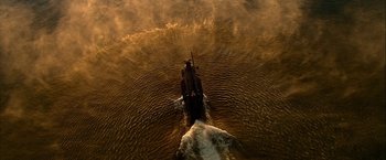 Movie still from “Act of Valor” (2012), directed by Scott Waugh – An aerial view of a boat in a body of water; Extreme Wide shot, Overhead angle