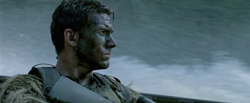 Movie still from “Act of Valor” (2012), directed by Scott Waugh – A person wearing a military uniform; Close Up shot, Over the shoulder angle