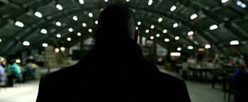 Movie still from “Act of Valor” (2012), directed by Scott Waugh – A man with a bald head in a dark room; Close Up shot, Low angle