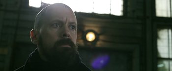 Movie still from “Act of Valor” (2012), directed by Scott Waugh – A man with a bald head looking up at the ceiling; Close Up shot, Low angle