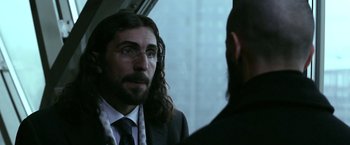 Movie still from “Act of Valor” (2012), directed by Scott Waugh – A man with long hair wearing a suit and tie; Close Up shot, Over the shoulder angle
