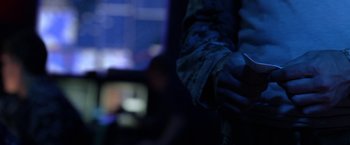 A person holding their hand over a television screen