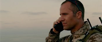 Movie still from “Act of Valor” (2012), directed by Scott Waugh – A man in a military uniform talking on a cell phone; Close Up shot, Low angle