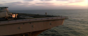 Movie still from “Act of Valor” (2012), directed by Scott Waugh – A man standing on the deck of an aircraft carrier; Extreme Wide shot, High angle