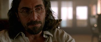 Movie still from “Act of Valor” (2012), directed by Scott Waugh – A man with long hair and a beard holding a cat; Close Up shot, Over the shoulder angle