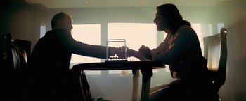 Movie still from “Act of Valor” (2012), directed by Scott Waugh – Two people sitting at a table holding hands; Medium shot, Low angle