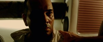 Movie still from “Act of Valor” (2012), directed by Scott Waugh – A man's face in a dark room; Close Up shot, Low angle