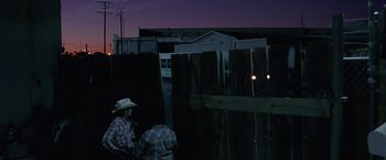Movie still from “Act of Valor” (2012), directed by Scott Waugh – Two men standing next to each other near a wooden fence; Extreme Wide shot, Over the shoulder angle