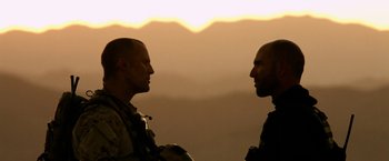 Movie still from “Act of Valor” (2012), directed by Scott Waugh – Two men facing one another in the dark; Close Up shot, Low angle