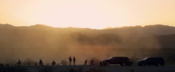 Movie still from “Act of Valor” (2012), directed by Scott Waugh – A group of people standing on top of a dirt field; Extreme Wide shot, Low angle