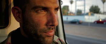 Movie still from “Act of Valor” (2012), directed by Scott Waugh – A man's face as he looks out the window of a car; Close Up shot, Over the shoulder angle