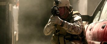 Movie still from “Act of Valor” (2012), directed by Scott Waugh – A man in a military uniform is holding a rifle; Close Up shot, Low angle