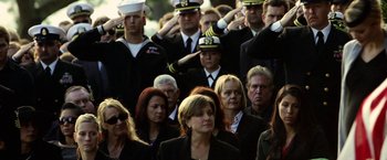 Movie still from “Act of Valor” (2012), directed by Scott Waugh – A group of people standing in a crowd saluting one another; Medium shot, High angle