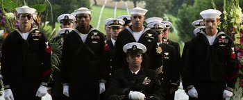 Movie still from “Act of Valor” (2012), directed by Scott Waugh – A group of men in navy uniforms standing next to each other; Wide shot, Low angle