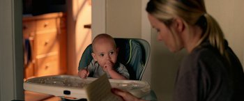 Movie still from “Act of Valor” (2012), directed by Scott Waugh – A baby sitting in a high chair looking at a woman; Close Up shot, Over the shoulder angle