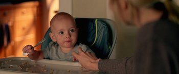Movie still from “Act of Valor” (2012), directed by Scott Waugh – A woman is holding a baby in a high chair; Close Up shot, Over the shoulder angle