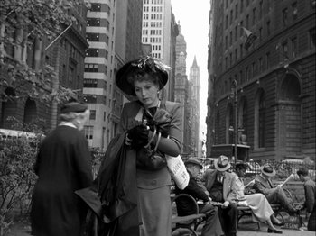 Movie still from “Adam's Rib” (1949), directed by George Cukor – An older woman is looking at her cell phone; Wide shot, Low angle