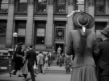 Movie still from “Adam's Rib” (1949), directed by George Cukor – An old photo of a crowd of people walking down the street; Medium shot, Low angle