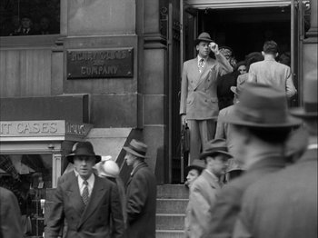 Movie still from “Adam's Rib” (1949), directed by George Cukor – A group of men standing on the steps of a building; Wide shot, High angle