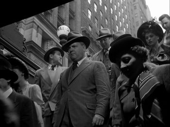 Movie still from “Adam's Rib” (1949), directed by George Cukor – A group of men and women standing on the sidewalk; Medium shot, Low angle