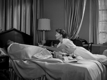 Movie still from “Adam's Rib” (1949), directed by George Cukor – A black and white photo of a woman laying on a bed; Medium shot, Low angle