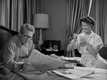 Movie still from “Adam's Rib” (1949), directed by George Cukor – An older man and woman are reading newspapers; Medium shot, Low angle