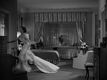 Movie still from “Adam's Rib” (1949), directed by George Cukor – A woman in a wedding dress running in a room; Wide shot, Low angle