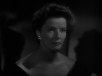 Movie still from “Adam's Rib” (1949), directed by George Cukor – An old photo of a woman in a black dress; Close Up shot, Low angle