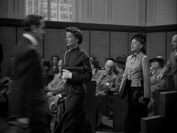 Movie still from “Adam's Rib” (1949), directed by George Cukor – Two women are walking in front of an audience; Medium shot, Low angle