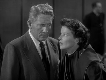 Movie still from “Adam's Rib” (1949), directed by George Cukor – An older man and a younger woman standing next to each other; Medium shot, High angle