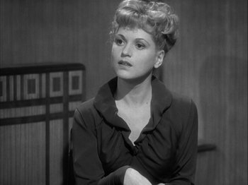 Movie still from “Adam's Rib” (1949), directed by George Cukor – A black and white photo of a woman in a black dress; Close Up shot, High angle