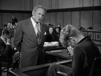 Movie still from “Adam's Rib” (1949), directed by George Cukor – An old photo of a man and woman in a court room; Medium shot, Low angle