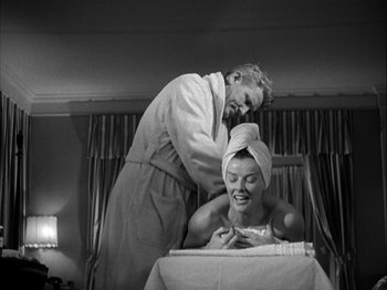 Movie still from “Adam's Rib” (1949), directed by George Cukor – An old photo of a man and a woman in a room; Medium shot, Low angle