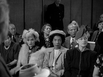 Movie still from “Adam's Rib” (1949), directed by George Cukor – A black and white photo of a group of people; Medium shot, Low angle