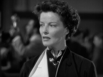 Movie still from “Adam's Rib” (1949), directed by George Cukor – An old photo of an older woman in a black suit; Close Up shot, Low angle
