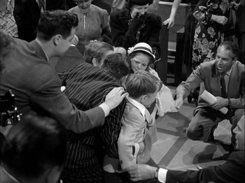 Movie still from “Adam's Rib” (1949), directed by George Cukor – A group of people standing around each other in a room; Medium shot, High angle