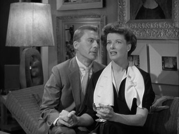 Movie still from “Adam's Rib” (1949), directed by George Cukor – An older man and a younger woman sitting next to each other; Medium shot, Low angle
