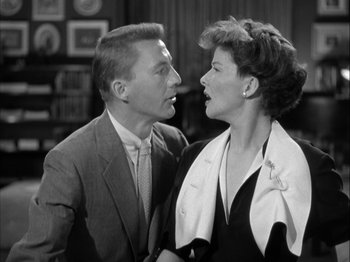 Movie still from “Adam's Rib” (1949), directed by George Cukor – A man and a woman standing next to each other in a room; Medium shot, Low angle