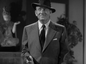 Movie still from “Adam's Rib” (1949), directed by George Cukor – An older man wearing a suit and hat holding a gun; Medium shot, Low angle